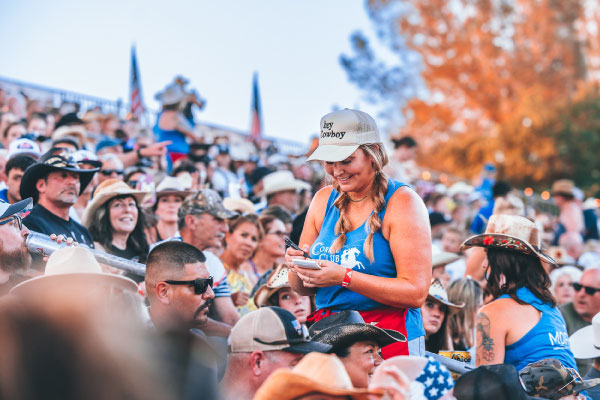 A female server taking orders in the corral club section at the Folsom Pro Rodeo